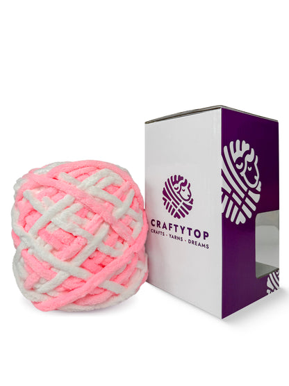 Craftytop Cotton Candy, a cotton candy pink chenille yarn skein outside the box, showcasing its thick and velvety fibers for knitting